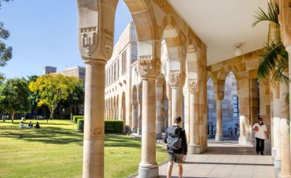 a view of a colonaded walkway next to green lawn